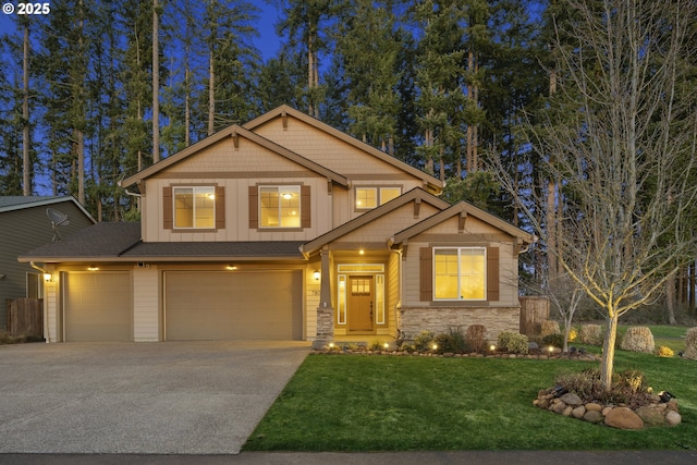 craftsman house with a garage and a front lawn