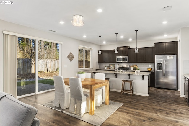 dining space with dark wood-type flooring and sink