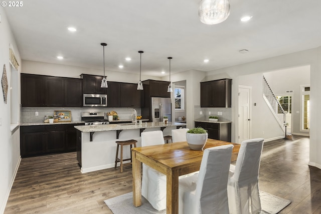 dining space with dark hardwood / wood-style flooring and sink