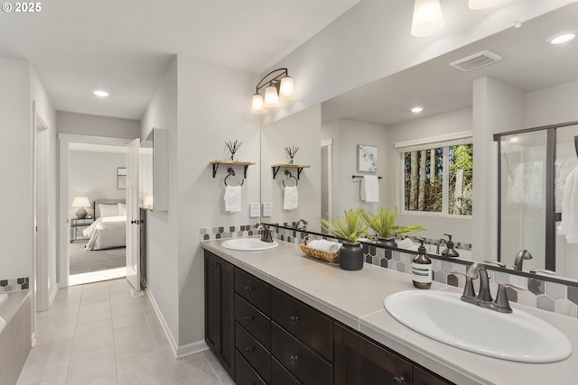 bathroom featuring vanity, a shower with shower door, and tile patterned flooring