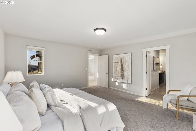 carpeted bedroom featuring ensuite bathroom