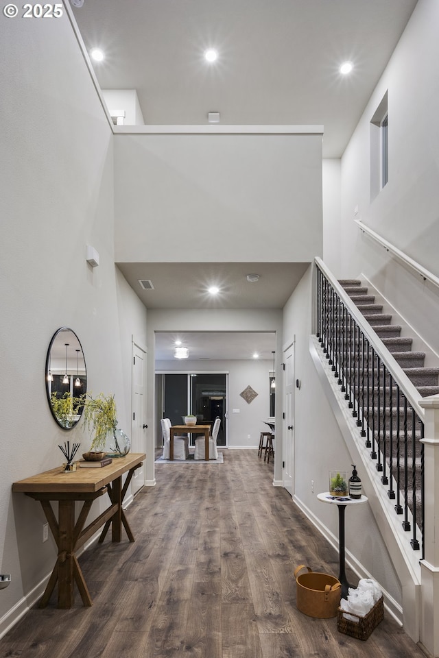 interior space with hardwood / wood-style floors and a high ceiling