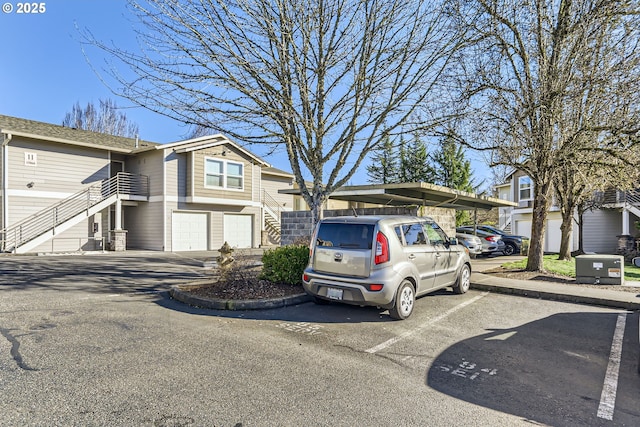 view of front of home with a garage and a carport