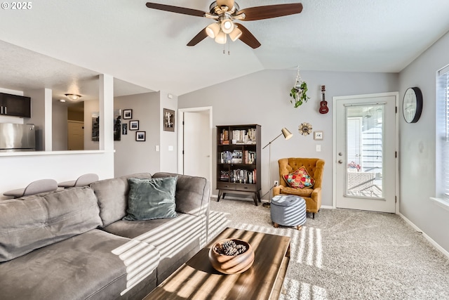 carpeted living room featuring vaulted ceiling and ceiling fan