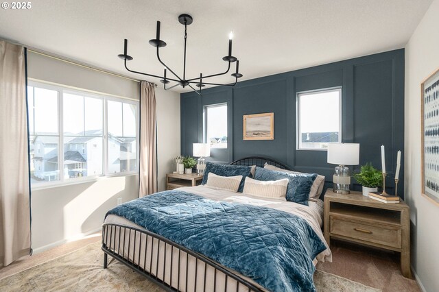 11331 NW Main St, North Plains, OR 97133 - bedroom featuring a chandelier, carpet, multiple windows, and baseboards