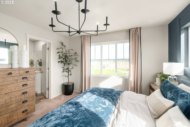 11331 NW Main St, North Plains, OR 97133 - bedroom with a chandelier, light colored carpet, baseboards, and connected bathroom