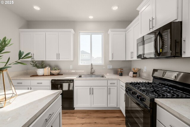 11331 NW Main St, North Plains, OR 97133 - kitchen with black appliances, a sink, white cabinets, light countertops, and recessed lighting
