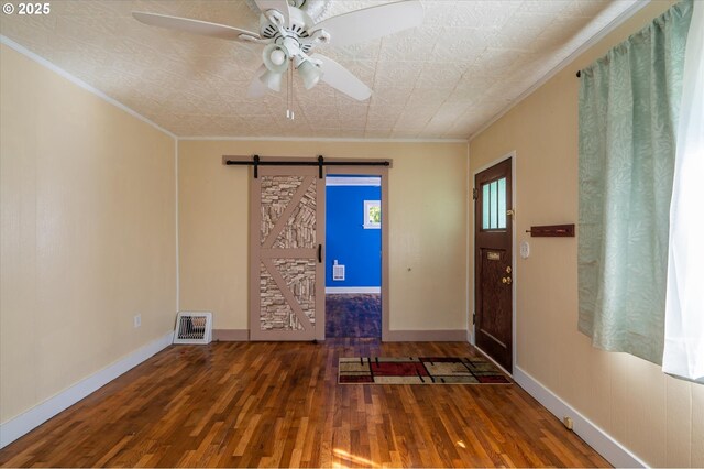 2318 Liberty St, North Bend, OR 97459 - foyer with wood finished floors, a barn door, ornamental molding, baseboards, and ceiling fan
