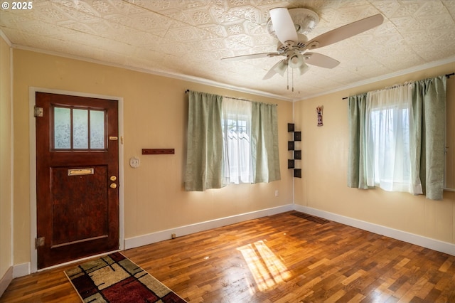 2318 Liberty St, North Bend, OR 97459 - foyer entrance featuring crown molding, wood finished floors, an ornate ceiling, a ceiling fan, and baseboards