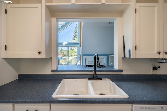 2318 Liberty St, North Bend, OR 97459 - kitchen featuring a sink, dark countertops, white cabinets, and dishwasher