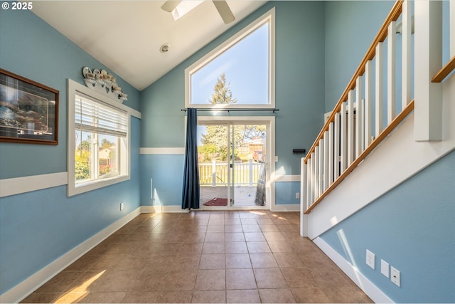 2318 Liberty St, North Bend, OR 97459 - tiled entrance foyer with high vaulted ceiling, stairs, a ceiling fan, and baseboards