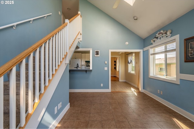 2318 Liberty St, North Bend, OR 97459 - stairs with tile patterned flooring, high vaulted ceiling, and baseboards