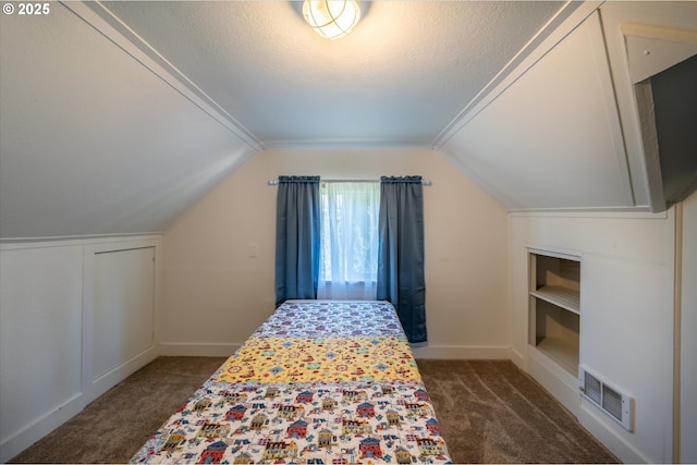 2318 Liberty St, North Bend, OR 97459 - bedroom with dark colored carpet, vaulted ceiling, baseboards, and a textured ceiling