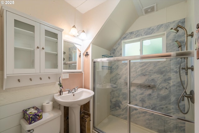 2318 Liberty St, North Bend, OR 97459 - bathroom featuring a stall shower, toilet, vaulted ceiling, and a sink