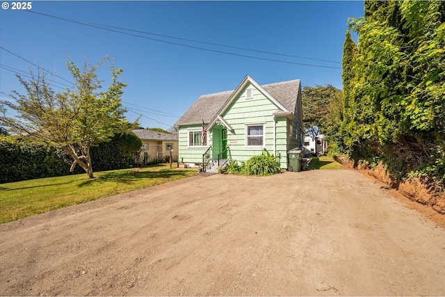 2318 Liberty St, North Bend, OR 97459 - bungalow-style home with a front lawn, roof with shingles, and dirt driveway