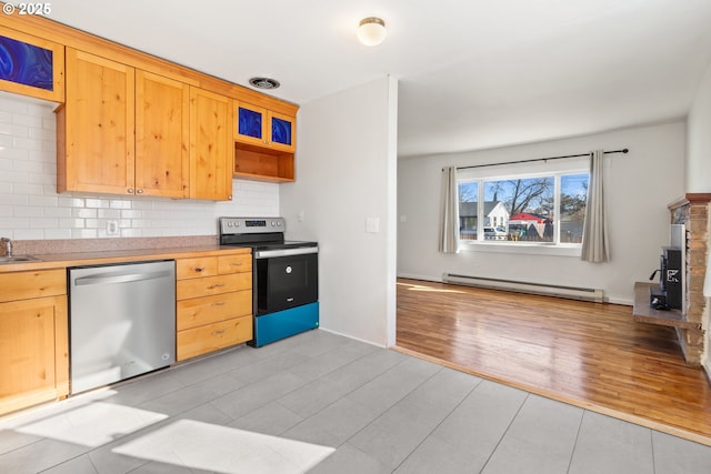 kitchen with appliances with stainless steel finishes, tasteful backsplash, sink, baseboard heating, and light wood-type flooring