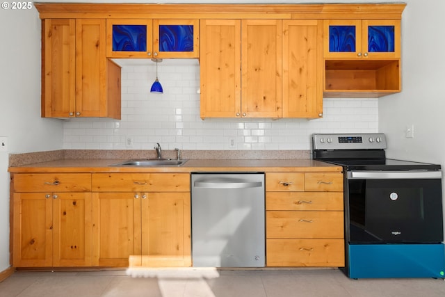 kitchen featuring tasteful backsplash, stainless steel appliances, sink, and light tile patterned floors