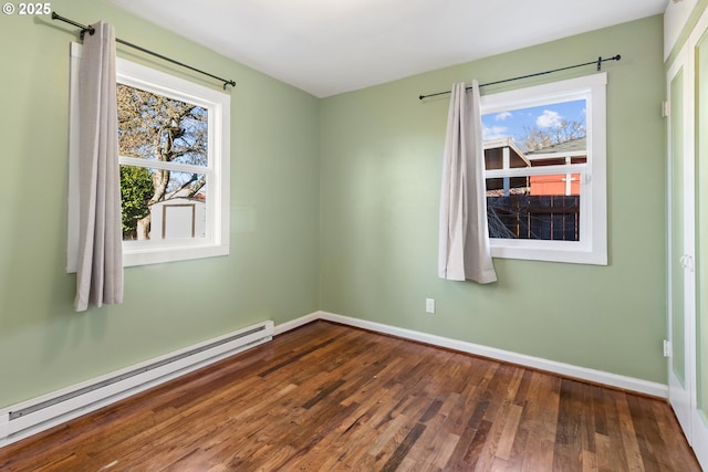 empty room with a baseboard radiator, dark hardwood / wood-style floors, and a wealth of natural light