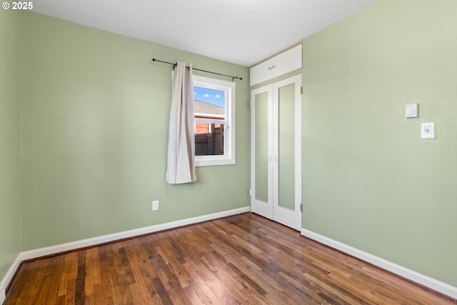 unfurnished room with wood-type flooring