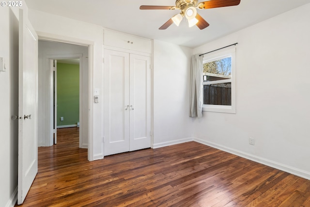 unfurnished bedroom with ceiling fan, dark hardwood / wood-style flooring, and a closet