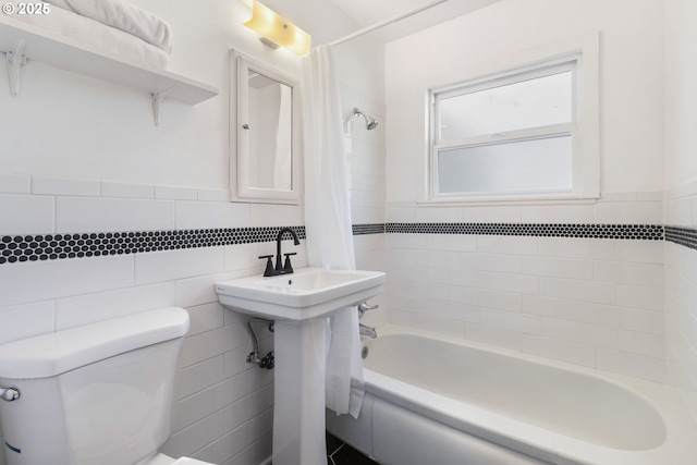 bathroom featuring tile walls, toilet, and shower / bath combo