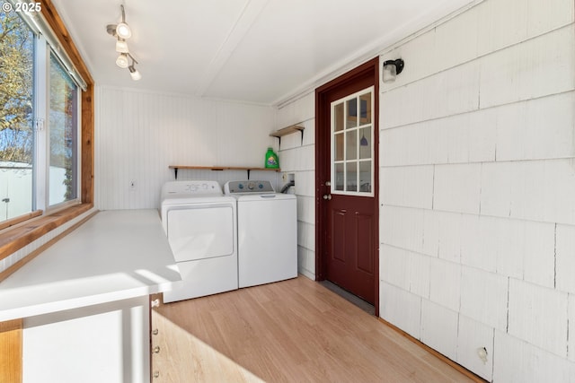 washroom featuring washing machine and clothes dryer and light wood-type flooring