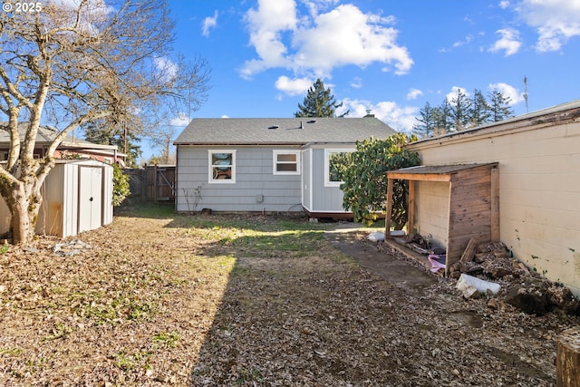 rear view of house featuring a storage unit