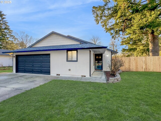 ranch-style house with a garage and a front yard