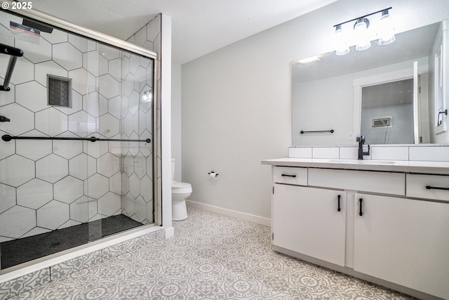 bathroom with vanity, toilet, a shower with shower door, and tile patterned flooring