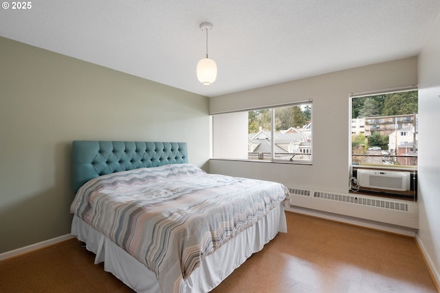 bedroom featuring cooling unit, baseboards, radiator, and carpet flooring