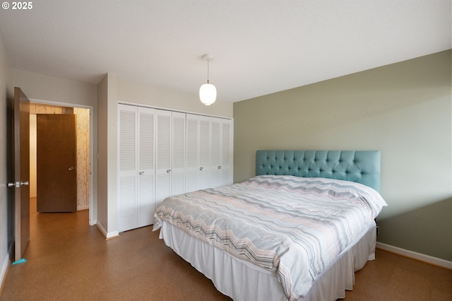 bedroom featuring baseboards and a closet