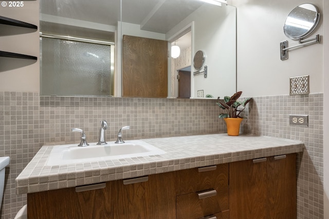 bathroom with an enclosed shower, tile walls, and vanity