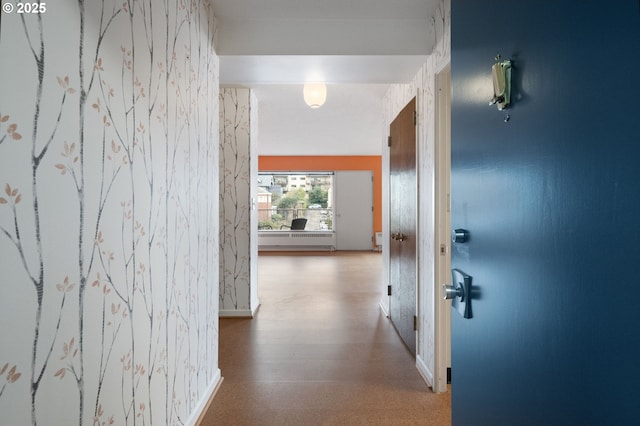 hallway with baseboards and wood finished floors