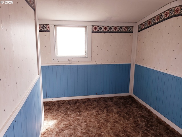 72584 Yarrington Rd, Elgin, OR 97827 - spare room featuring a wainscoted wall, carpet floors, and wooden walls