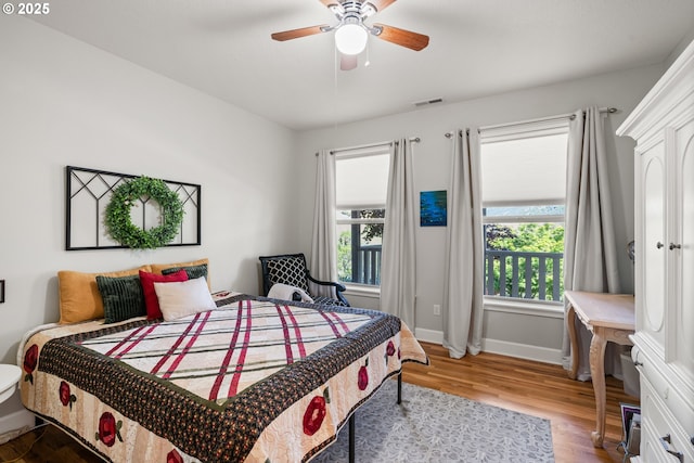 2809 Dead Indian Memorial Rd, Ashland, OR 97520 - bedroom with baseboards, a ceiling fan, wood finished floors, and visible vents