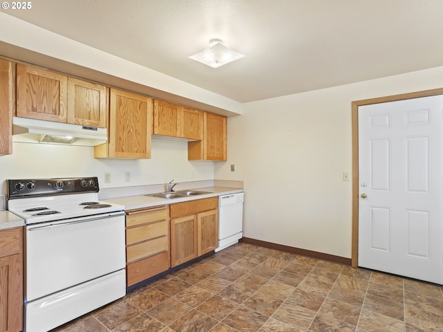 kitchen featuring white appliances, baseboards, a sink, light countertops, and under cabinet range hood