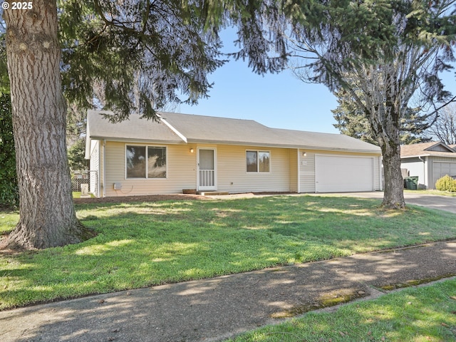 ranch-style house with an attached garage, concrete driveway, and a front yard