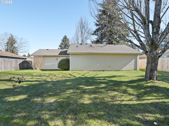 exterior space with a yard and fence