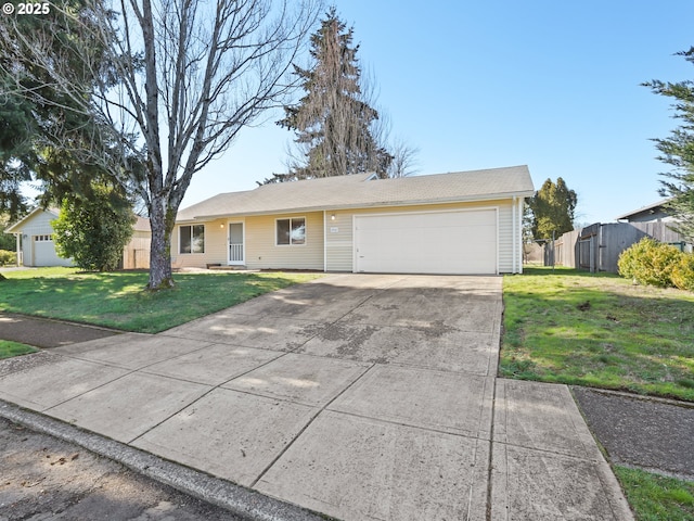 ranch-style house featuring a front yard, an attached garage, fence, and driveway