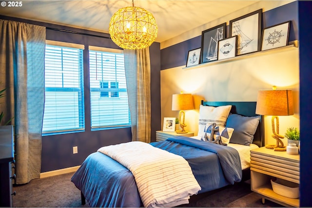 carpeted bedroom with a notable chandelier