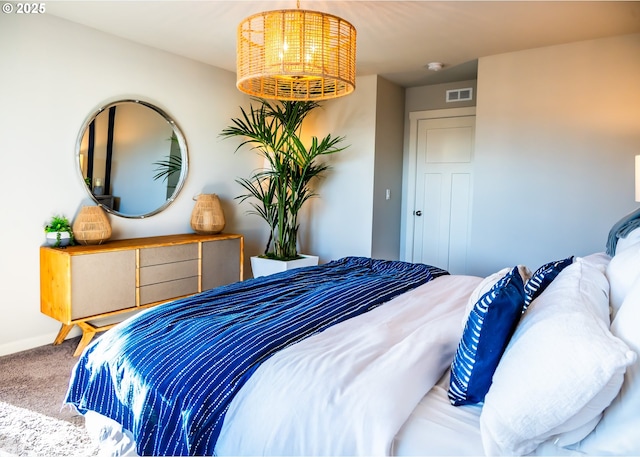 carpeted bedroom with a chandelier