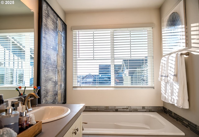 bathroom with a washtub and vanity