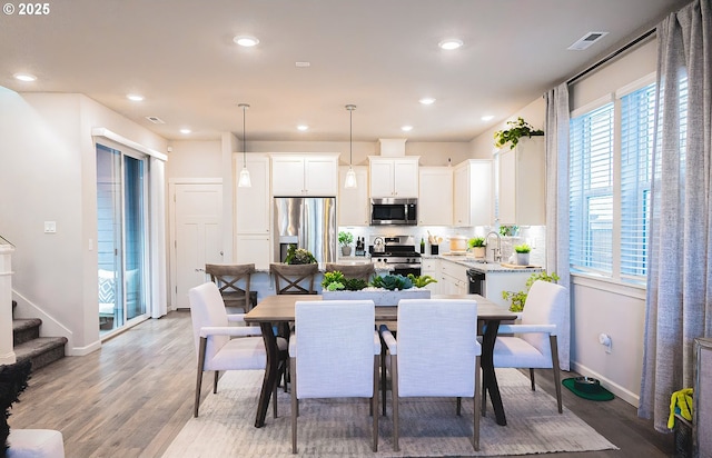 dining room featuring hardwood / wood-style flooring and sink