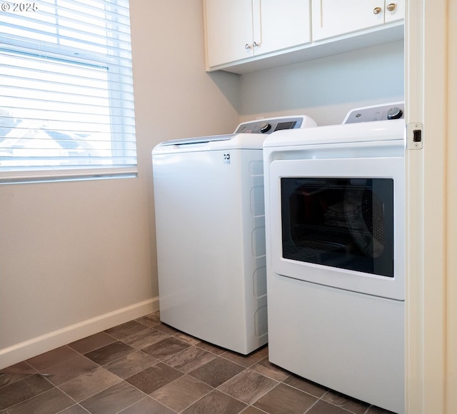 laundry area with cabinets and washing machine and clothes dryer