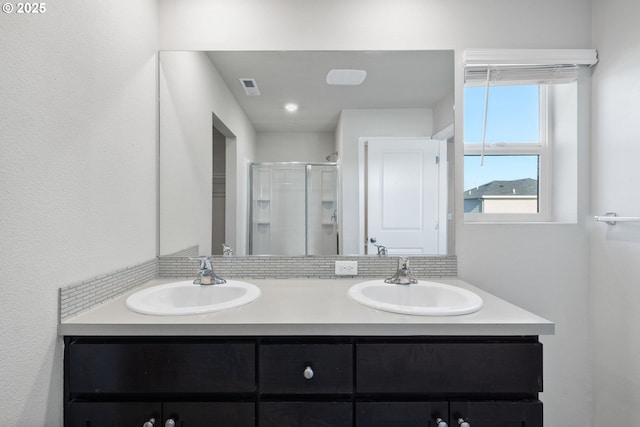 bathroom featuring vanity and a shower with shower door