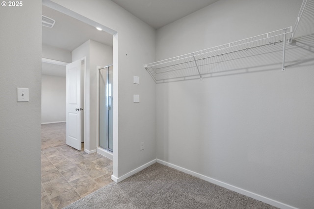 spacious closet featuring light carpet