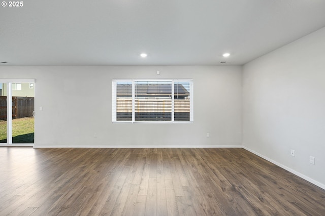 unfurnished room with dark wood-type flooring