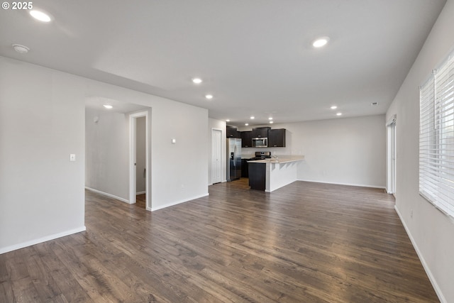 unfurnished living room with dark hardwood / wood-style floors