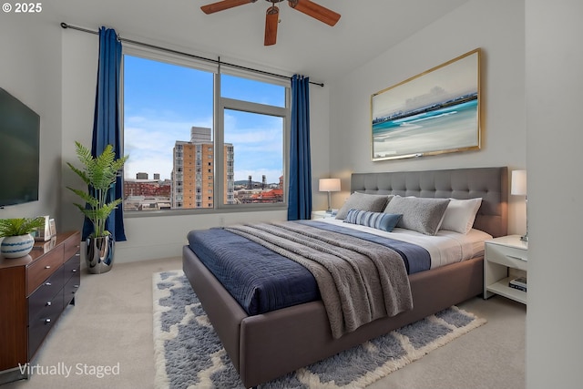 bedroom featuring light carpet and ceiling fan