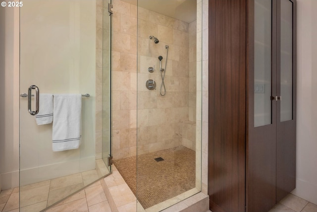 bathroom featuring tile patterned flooring and a shower with shower door